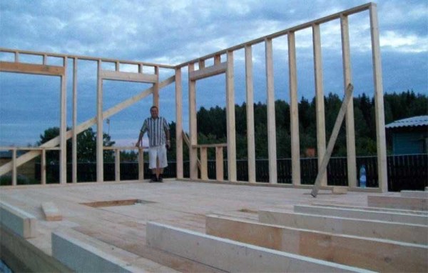 Une option pour l'assemblage progressif de la charpente de la maison: les poteaux d'angle sont exposés et fixés, le cerclage supérieur est immédiatement monté dessus, puis les poteaux verticaux avec l'étape choisie