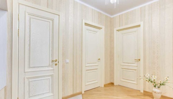 Dans le couloir aux portes lumineuses, le papier peint semble plus organique avec la lumière