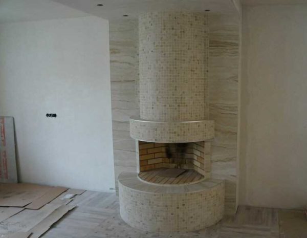 Il s'agit de grès cérame brut de petit format. Comme vous pouvez le voir, il s'intègre bien dans les formes arrondies. Les surfaces horizontales et les colonnes sont également en grès cérame avec une texture similaire, mais déjà sous la forme de dalles
