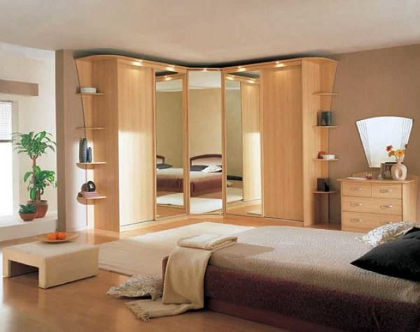 Une armoire d'angle dans la chambre est un excellent moyen de cacher tout ce qui est inutile