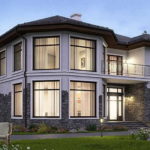 La forme inhabituelle de la maison est soulignée par de grandes fenêtres